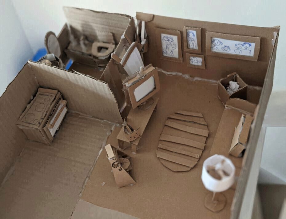 a homemade cardboard sculpture of a house