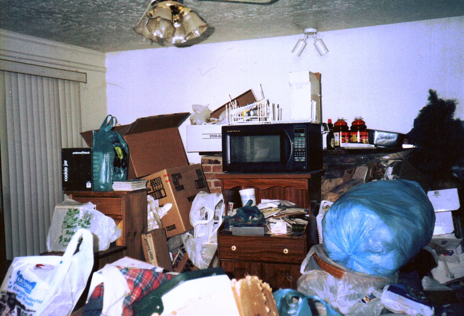 a picture of a hoarders room, very messy, with piles of things
